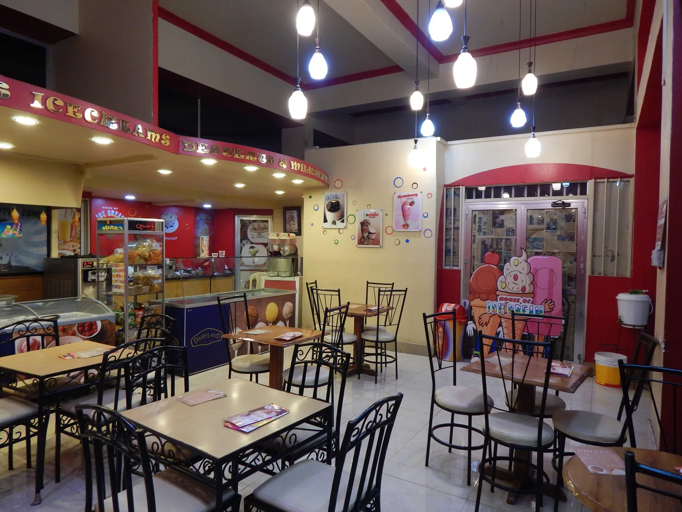 A later view of the red parlour with a wider service counter and more seating.